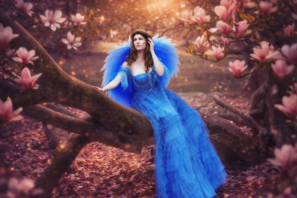 Elena Frizler Shooting mit blauem Kleid Engelsflügeln und Magnolien in Luzern