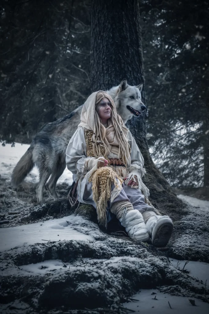 Frostfall Fantasy Szene mit Schamanin im verschneiten Wald mit Wolfshund ruhige mystische Fine Art Fotografie und inszeniertes Fotoshooting Schweiz